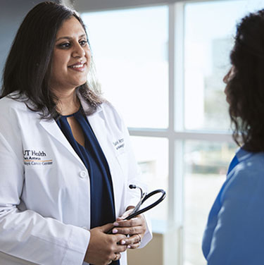 Dr. Arora talking to a patient 