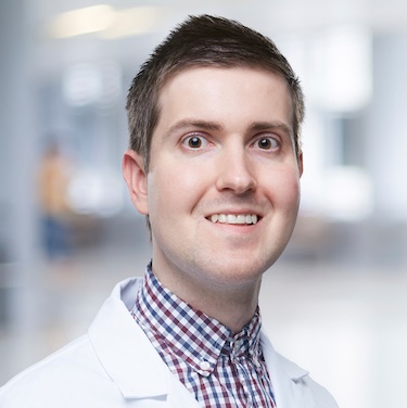 A headshot of Dr. Robert Christopher Gilson in his white coat