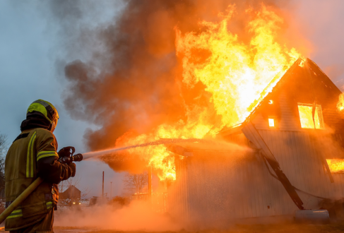 Firefighters extinguishing a house fire